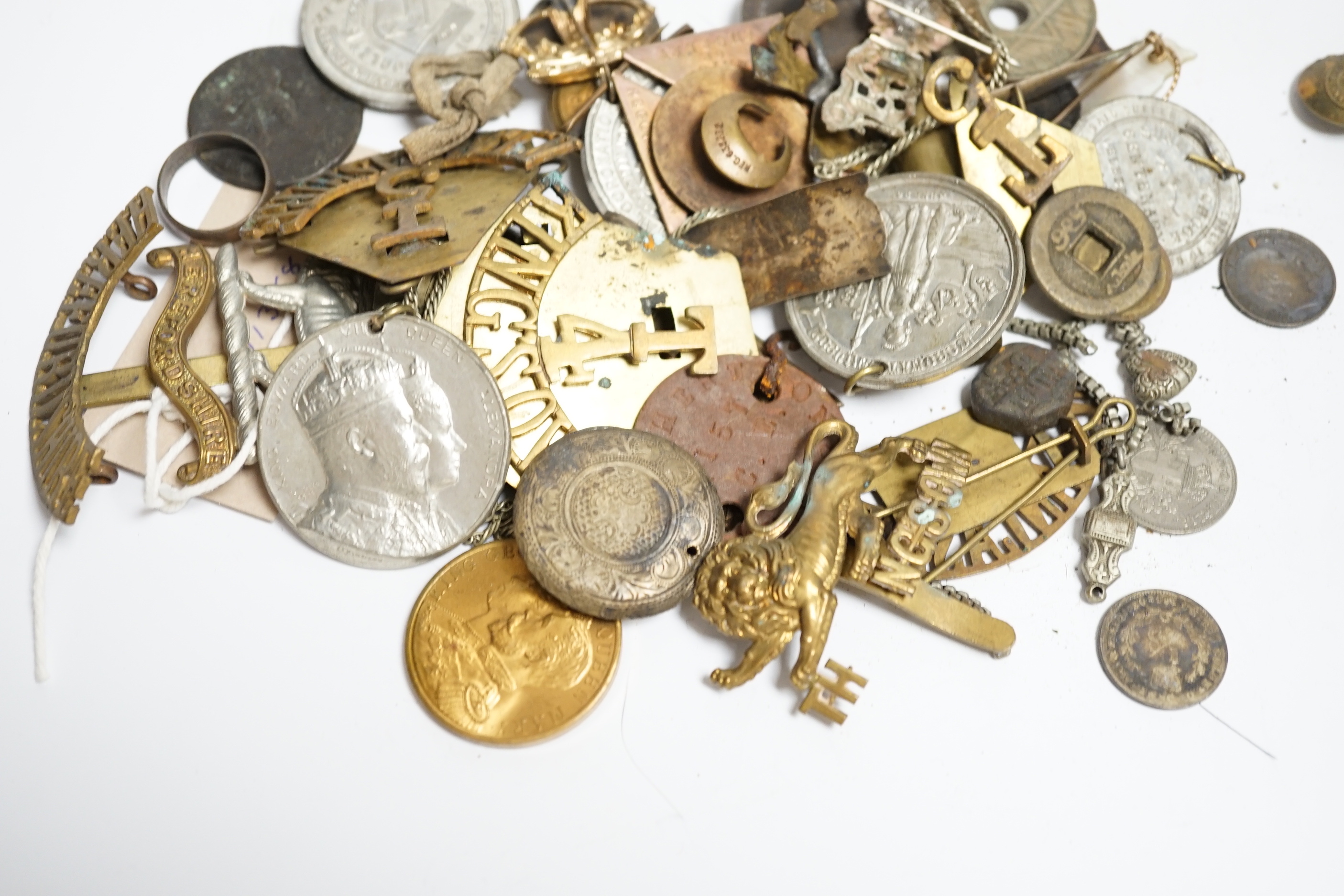 A quantity of military cap badges, etc.
